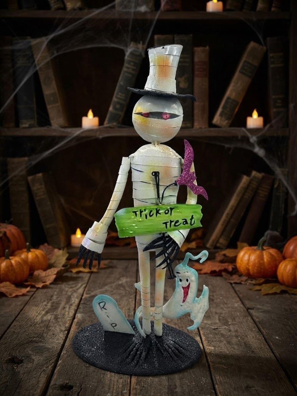 White Mummy Halloween Sculpture with Green 'Trick or Treat' Sign